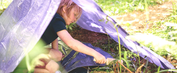 boy builds a purple den