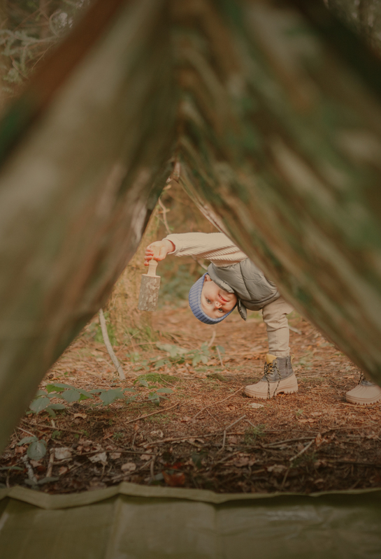 child peeking through den