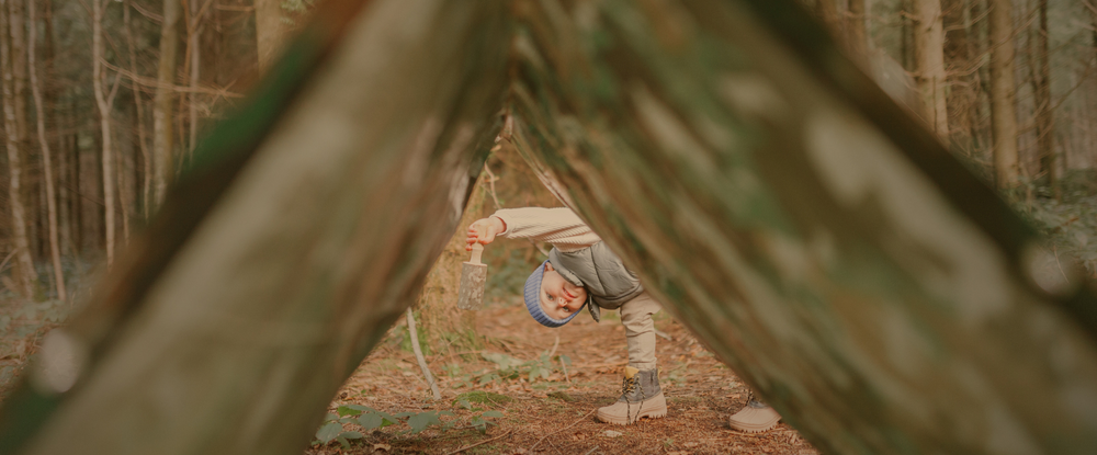 child peeking through den