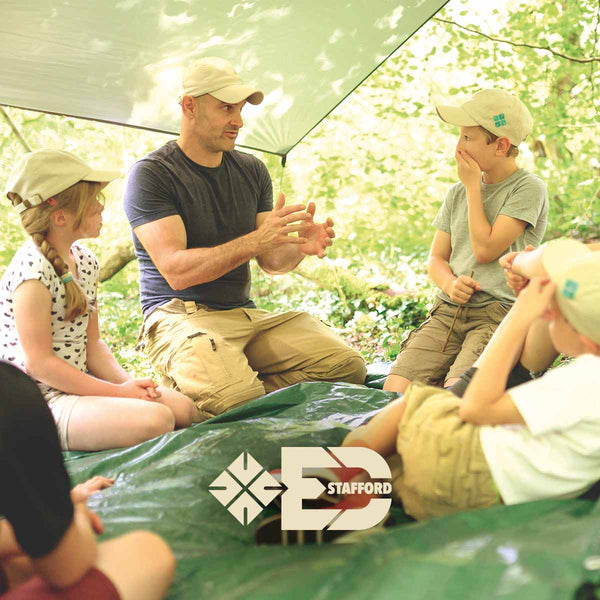 Ed Stafford playing with kids and the Shelter Kit