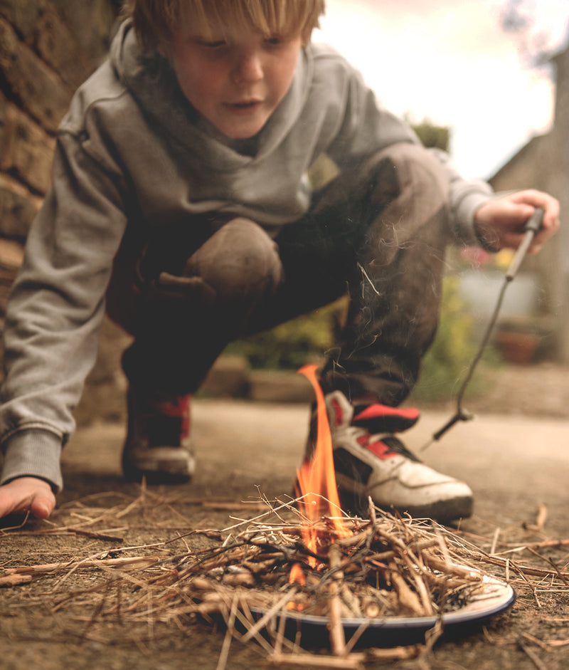 Boy playing with Fire on a Plate kit